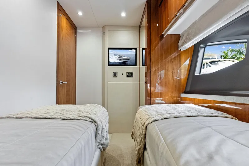 Miller Time Yacht Photos Pics Interior of 2021 Sunseeker Manhattan 52 yacht with twin beds and window view.