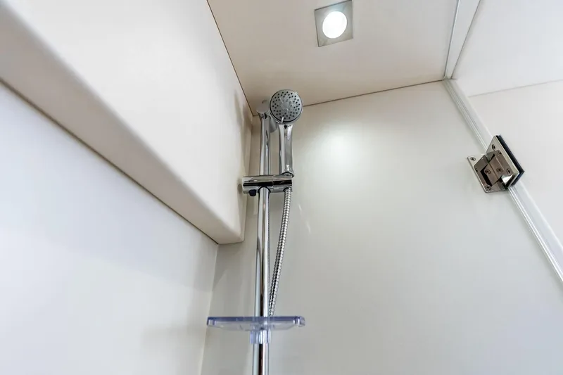 Miller Time Yacht Photos Pics Shower area in 2021 Sunseeker Manhattan 52 yacht, featuring modern fixtures and lighting.