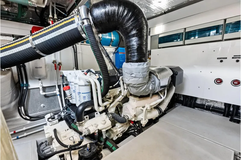 Miller Time Yacht Photos Pics Engine room of 2021 Sunseeker Manhattan 52 yacht, showcasing advanced machinery and piping.