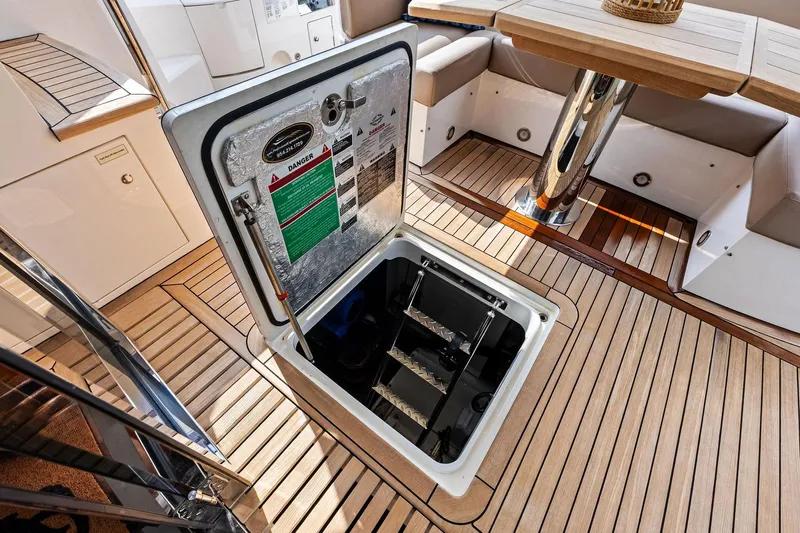 Miller Time Yacht Photos Pics Sunseeker Manhattan 52 yacht interior with open hatch and wooden flooring, 2021 model.
