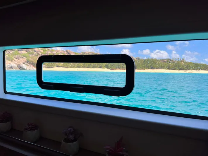 Vienna Yacht Photos Pics View of tropical beach through Fountaine Pajot Catamaran Aura 51 window, 2022 model.