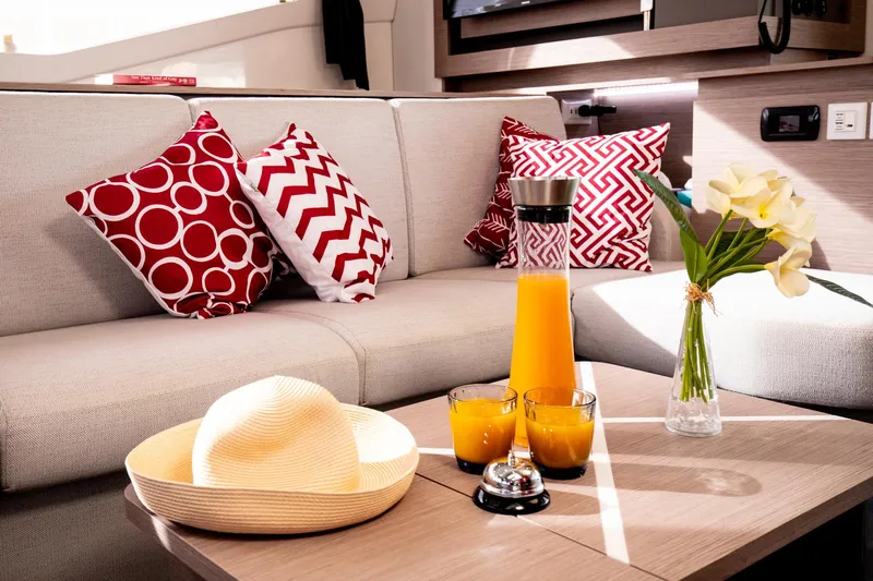 Vienna Yacht Photos Pics Luxurious interior of 2022 Fountaine Pajot Catamaran Aura 51 with vibrant decor and refreshments.