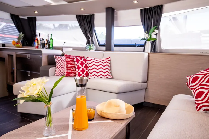 Vienna Yacht Photos Pics Luxurious interior of 2022 Fountaine Pajot Catamaran Aura 51 with modern decor and vibrant cushions.