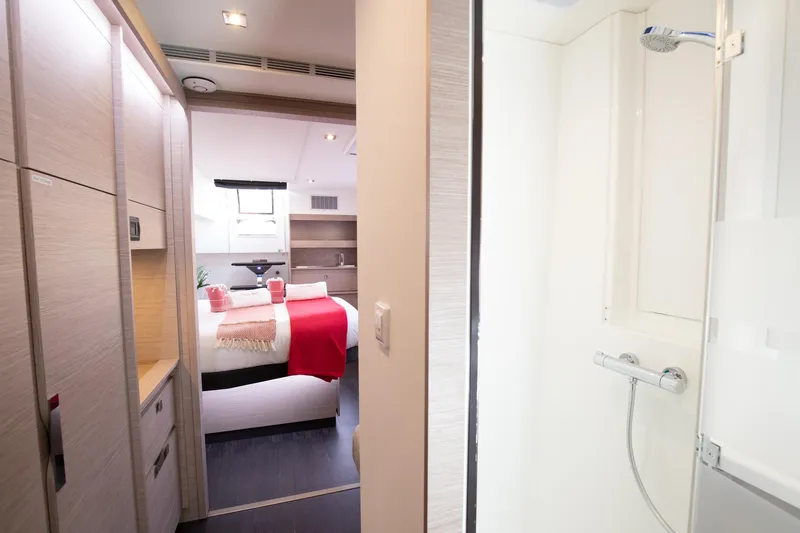 Vienna Yacht Photos Pics Luxurious interior of 2022 Fountaine Pajot Catamaran Aura 51, featuring bedroom and shower.