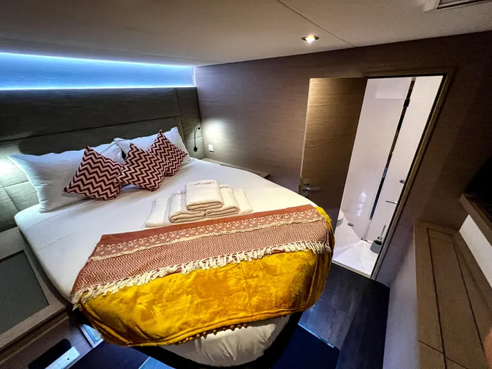 Vienna Yacht Photos Pics Luxurious bedroom in 2022 Fountaine Pajot Catamaran Aura 51 with modern decor and cozy lighting.