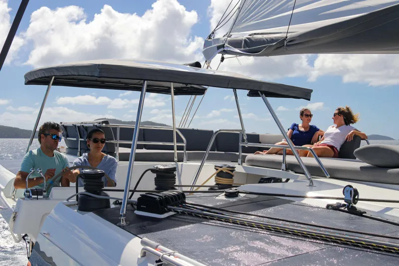 Vienna Yacht Photos Pics People relaxing on a 2022 Fountaine Pajot Catamaran Aura 51 under sunny skies.