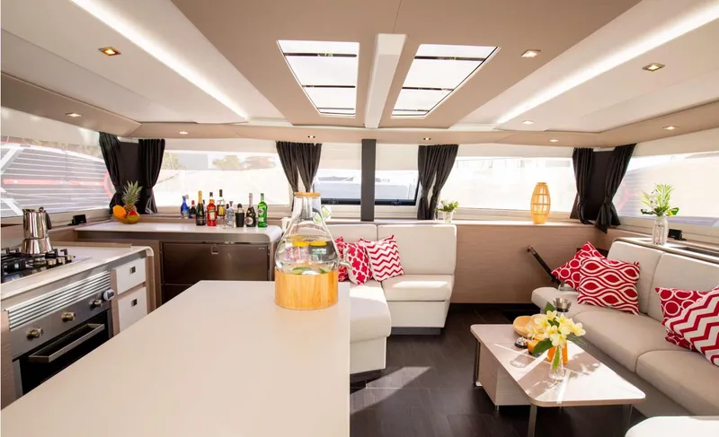 Vienna Yacht Photos Pics Luxurious interior of 2022 Fountaine Pajot Catamaran Aura 51 with modern kitchen and seating area.