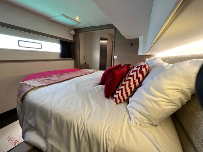 Vienna Yacht Photos Pics Luxurious bedroom interior of 2022 Fountaine Pajot Catamaran Aura 51 with elegant bedding.
