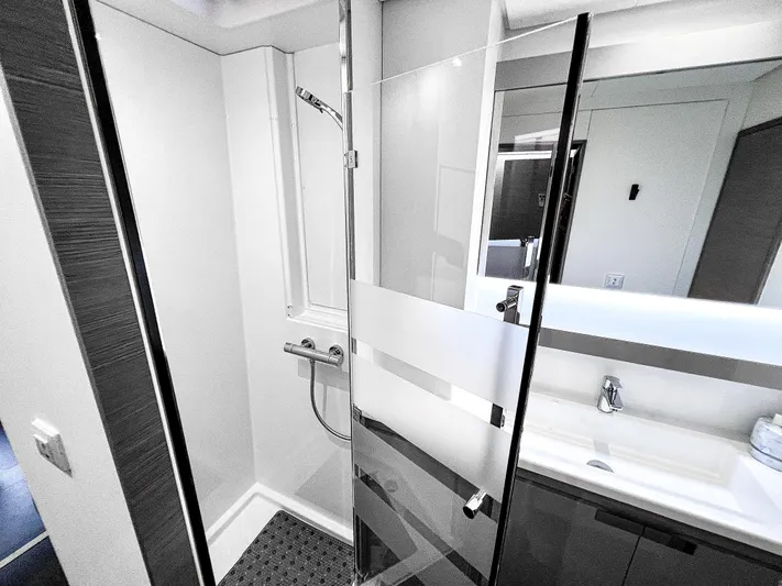 Vienna Yacht Photos Pics Modern bathroom in 2022 Fountaine Pajot Catamaran Aura 51, featuring sleek shower and vanity.