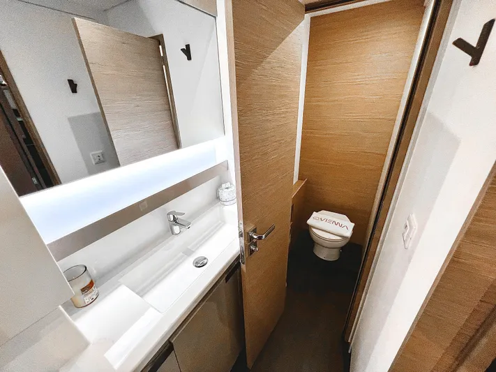 Vienna Yacht Photos Pics 2022 Fountaine Pajot Aura 51 catamaran bathroom with modern sink and toilet.