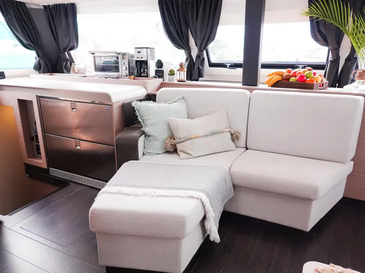 Vienna Yacht Photos Pics Luxurious interior of 2022 Fountaine Pajot Catamaran Aura 51 with modern kitchen and cozy seating.
