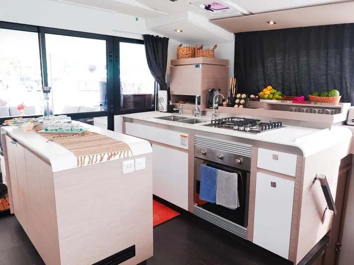 Vienna Yacht Photos Pics Modern kitchen interior of 2022 Fountaine Pajot Catamaran Aura 51 with sleek design and amenities.