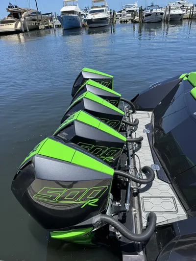 Crypto Excepted! Yacht Photos Pics Four green 500R outboard motors on a 2023 Adrenaline 47 boat at a marina.