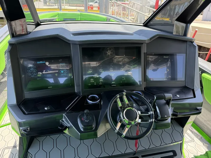 Crypto Excepted! Yacht Photos Pics Cockpit of 2023 Adrenaline 47 boat with advanced digital displays and steering wheel.