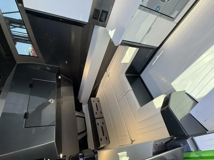 Crypto Excepted! Yacht Photos Pics Modern interior of 2023 Adrenaline 47 boat with sleek design and comfortable seating.