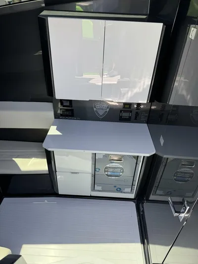 Crypto Excepted! Yacht Photos Pics Modern interior of 2023 Adrenaline 47 boat with sleek cabinetry and control panels.