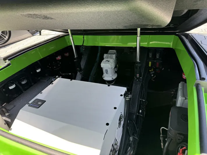 Crypto Excepted! Yacht Photos Pics Engine compartment of 2023 Adrenaline 47 boat, featuring modern components and vibrant green accents.