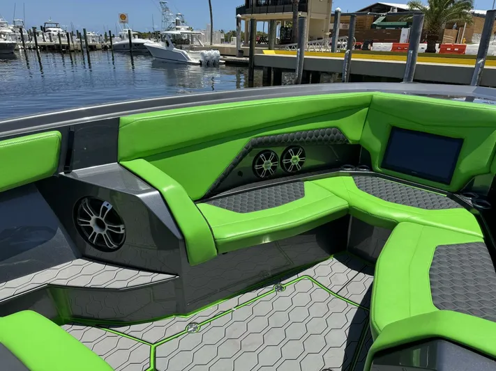 Crypto Excepted! Yacht Photos Pics Luxury Adrenaline 47 boat interior with vibrant green seating, modern design, and waterfront view.