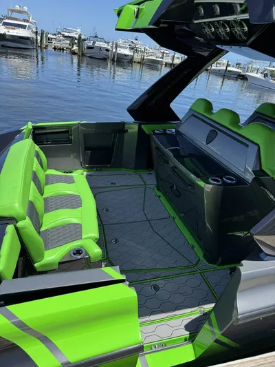 Crypto Excepted! Yacht Photos Pics Luxury Adrenaline 47 boat interior with vibrant green seating, docked at marina, 2023 model.