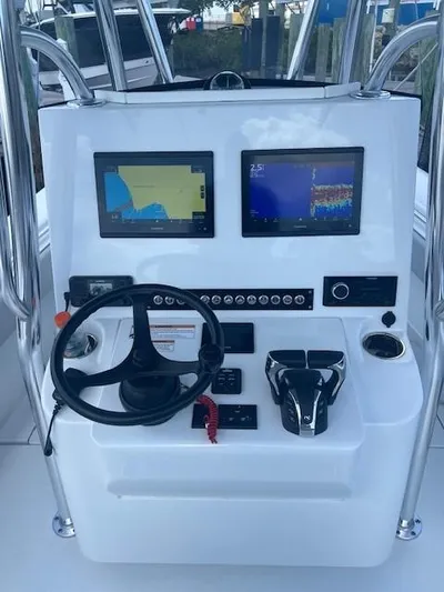  Yacht Photos Pics 2023 Contender 25 Tournament boat console with dual navigation screens and steering wheel.