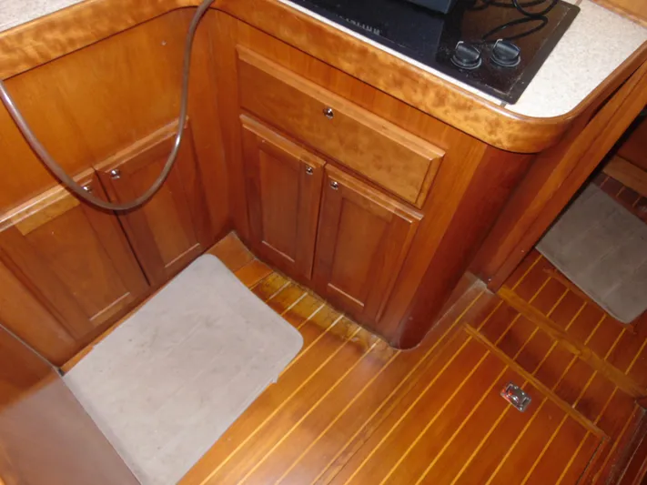 Lady Susan Yacht Photos Pics 2004 Sabre 36 Flybridge yacht interior with wooden cabinetry and flooring.