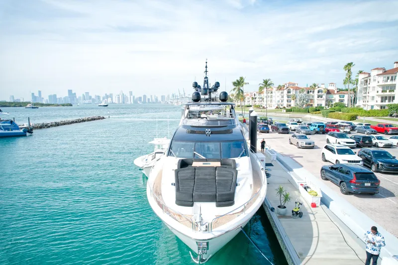 Alexa Yacht Photos Pics 2018 Sunseeker 86 Yacht docked at a marina with city skyline in the background.