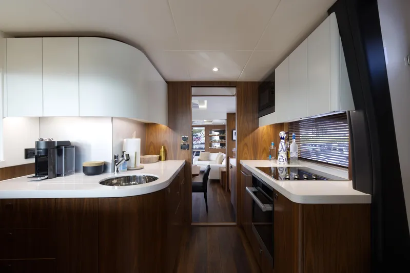 Alexa Yacht Photos Pics Modern kitchen interior of 2018 Sunseeker 86 Yacht with sleek wood and white finishes.