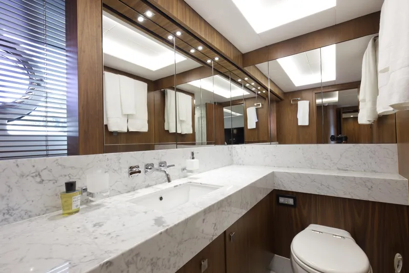 Alexa Yacht Photos Pics Luxurious bathroom in a 2018 Sunseeker 86 Yacht with marble countertops and wooden accents.