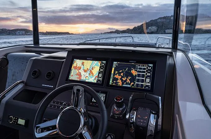  Yacht Photos Pics Cockpit view of 2024 Nimbus C-11 boat with navigation screens at sunset.