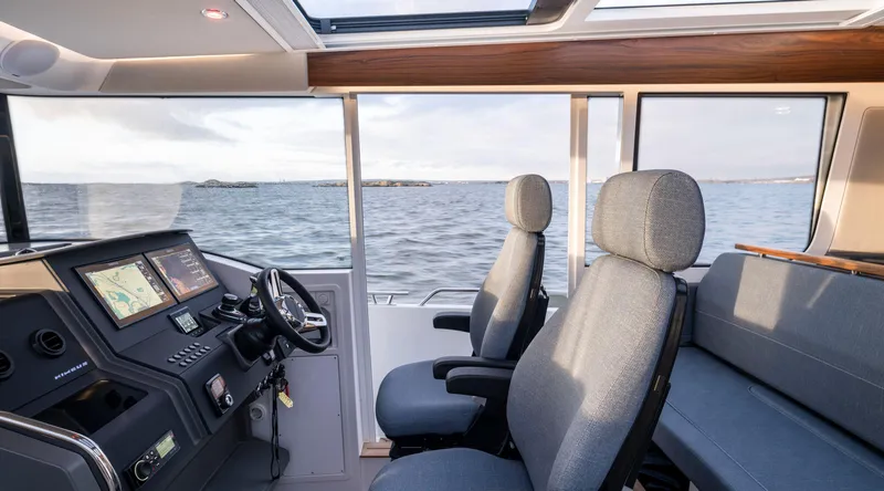  Yacht Photos Pics Interior of 2024 Nimbus C-11 boat with modern navigation system and comfortable seating.