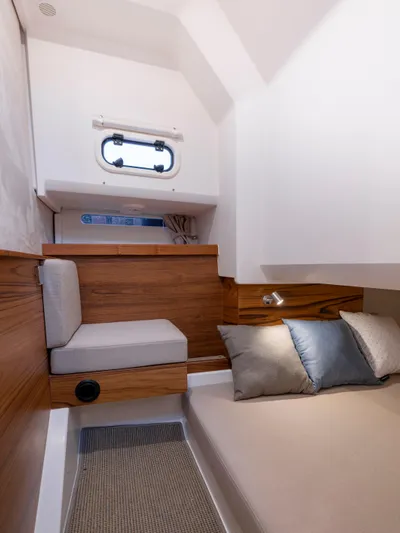  Yacht Photos Pics 2024 Nimbus C-11 cabin interior with cozy bed and seating area.