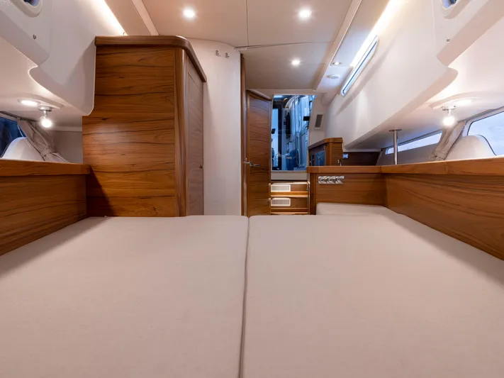  Yacht Photos Pics Luxurious interior of 2024 Nimbus C-11 yacht with wooden finishes and cozy bedding.