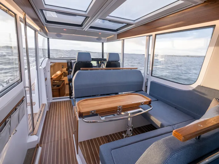  Yacht Photos Pics Interior of 2024 Nimbus C-11 boat with modern seating and panoramic windows.