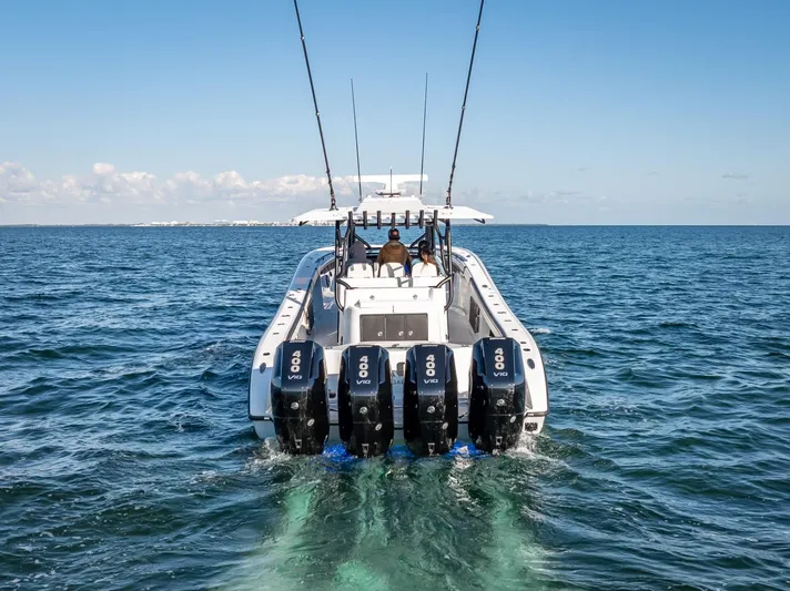  Yacht Photos Pics 2024 Yellowfin 42 boat with four powerful engines cruising on open water.