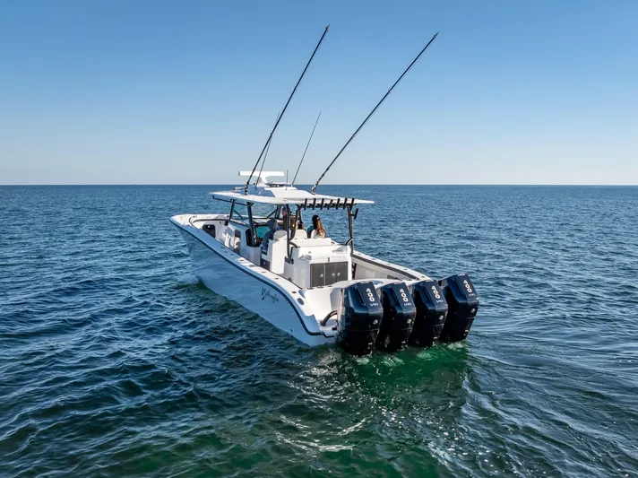  Yacht Photos Pics 2024 Yellowfin 42 boat with four engines cruising on open water.