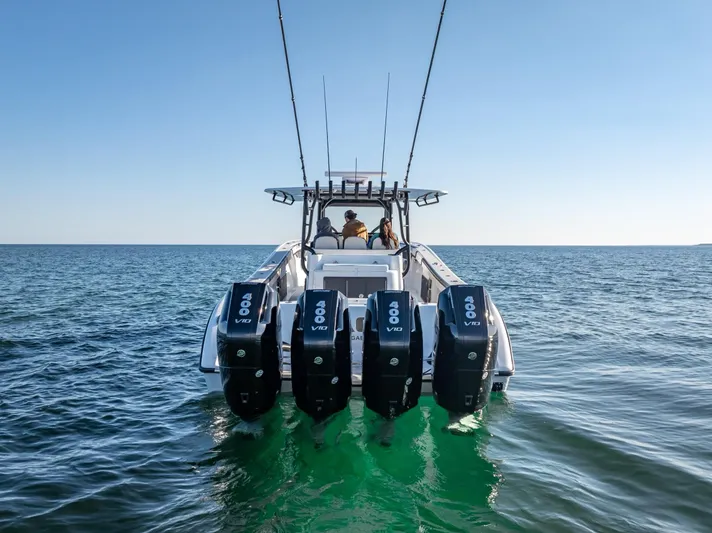  Yacht Photos Pics 2024 Yellowfin 42 boat with four powerful outboard engines on open water.
