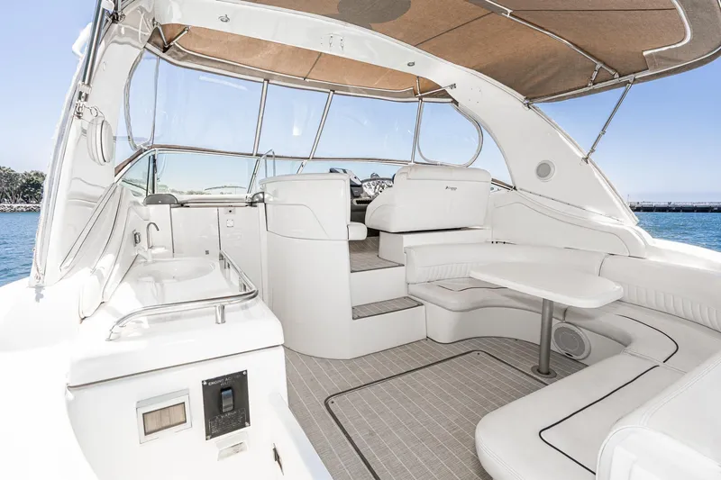 My Jojo Yacht Photos Pics 2005 Cruisers Yachts 370 Express interior with seating, table, and helm, overlooking the water.