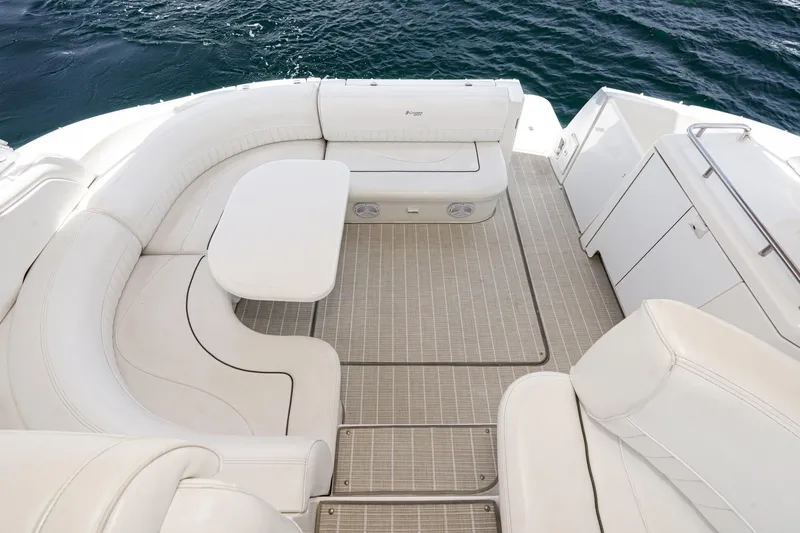 My Jojo Yacht Photos Pics 2005 Cruisers Yachts 370 Express interior with white seating and table on deck.