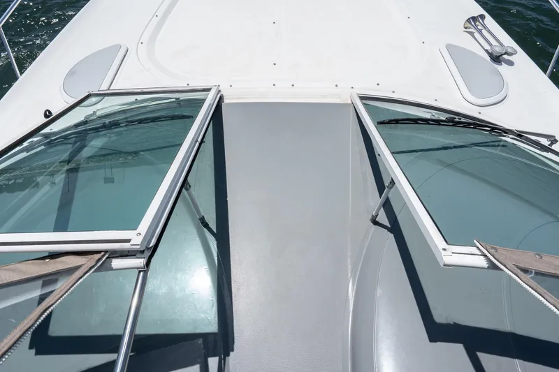 My Jojo Yacht Photos Pics 2005 Cruisers Yachts 370 Express deck with open windshield, showcasing sleek design.