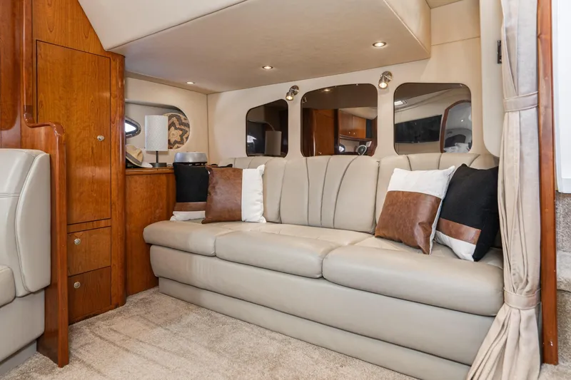 My Jojo Yacht Photos Pics Luxurious interior of 2005 Cruisers Yachts 370 Express with beige leather seating and wooden accents.