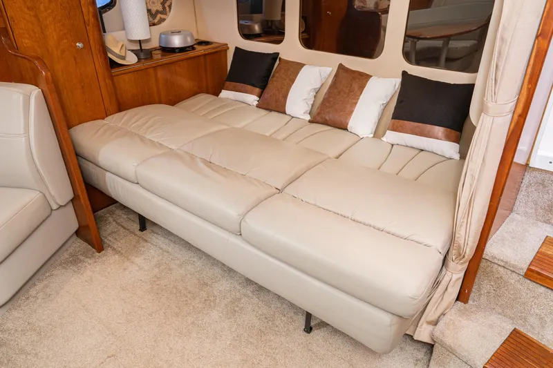 My Jojo Yacht Photos Pics Luxurious interior of 2005 Cruisers Yachts 370 Express with beige leather seating and decorative pillows.