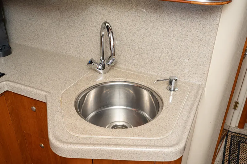 My Jojo Yacht Photos Pics 2005 Cruisers Yachts 370 Express kitchen sink with modern faucet and countertop.