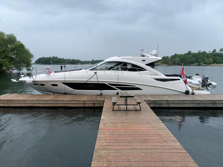 Flot D'amour Xx Yacht Photos Pics 2014 Sea Ray 510 Sundancer yacht docked on a serene lake.