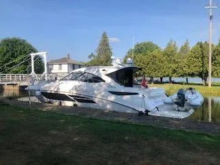 Flot D'amour Xx Yacht Photos Pics 2014 Sea Ray 510 Sundancer yacht docked by a canal with trees and house nearby.