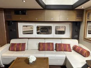 Flot D'amour Xx Yacht Photos Pics Luxurious interior of 2014 Sea Ray 510 Sundancer with white leather seating and colorful cushions.