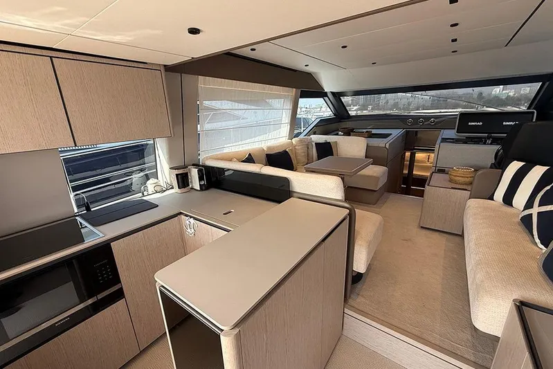 Aslid Yacht Photos Pics Luxurious interior of 2025 Ferretti Yachts 580, featuring modern kitchen and elegant seating area.