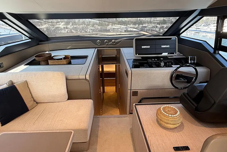 Aslid Yacht Photos Pics Luxurious interior of 2025 Ferretti Yachts 580 with modern helm and seating area.
