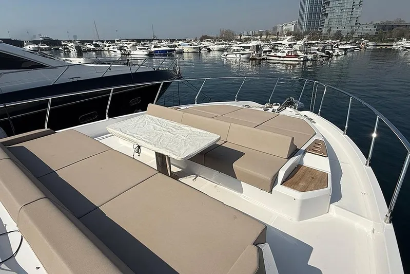 Aslid Yacht Photos Pics Luxurious 2025 Ferretti Yachts 580 with spacious deck seating in a marina setting.