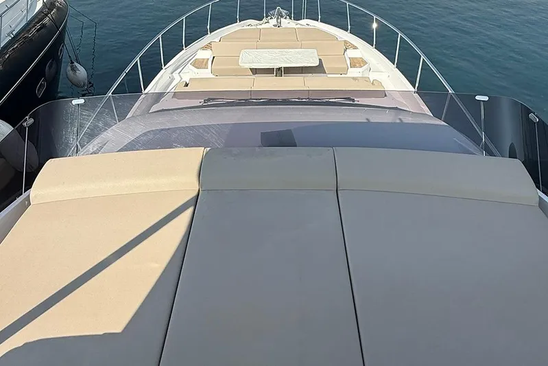 Aslid Yacht Photos Pics 2025 Ferretti Yachts 580, luxury yacht deck with sunbathing area, docked at marina.