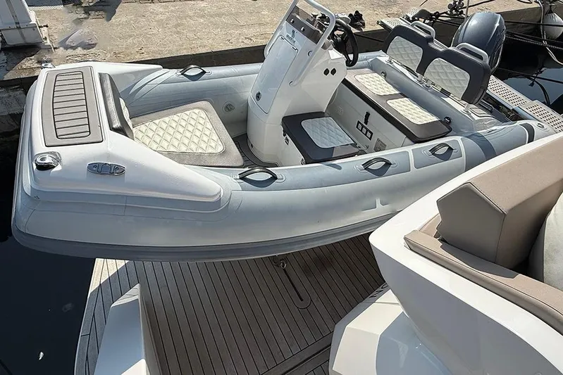 Aslid Yacht Photos Pics RIB boat docked on Ferretti Yachts 580, 2025 model, with cushioned seating.